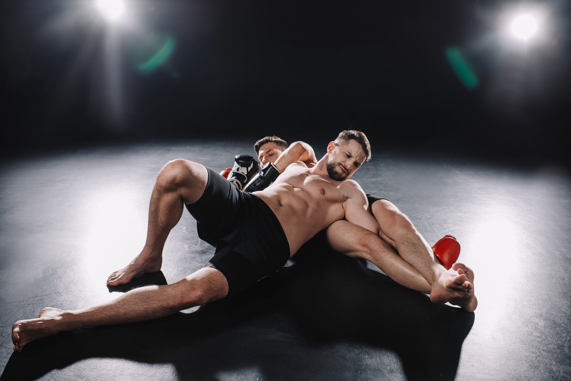 Two grapplers fighting for position under arena lights