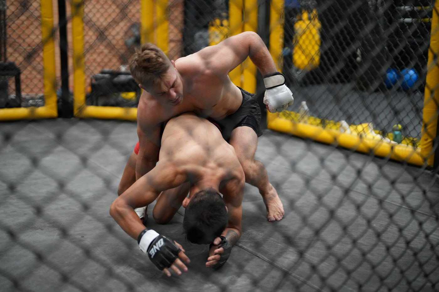 Two grapplers battling from a front headlock on the canvas